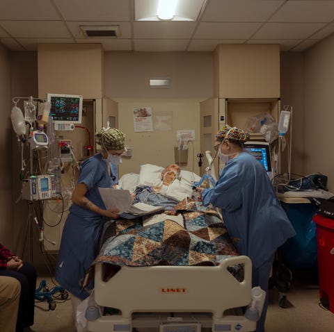 a medical team takes care of an ailing patient a medical team takes care of an ailing patient