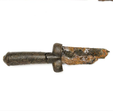 collection of historical artifacts including projectiles and a blade collection of historical artifacts including projectiles and a blade